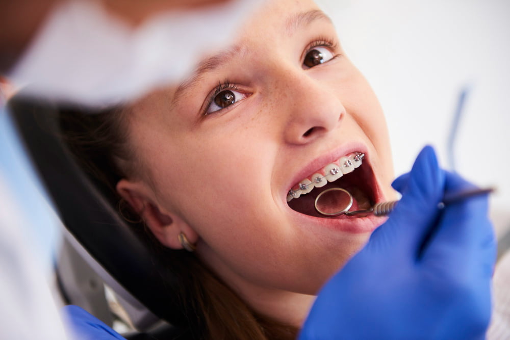 girl with braces during routine dental
